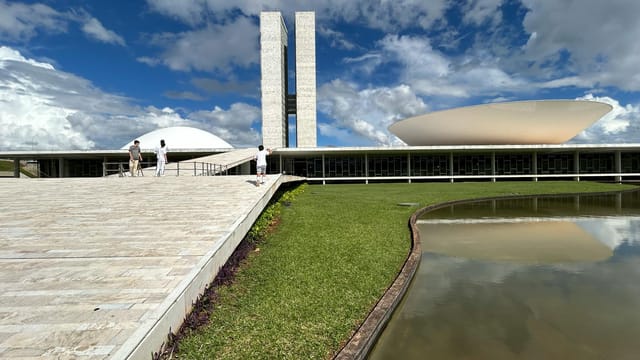 Stunning view of the National Congress of Brazil with its iconic modern architecture under a bright sky.