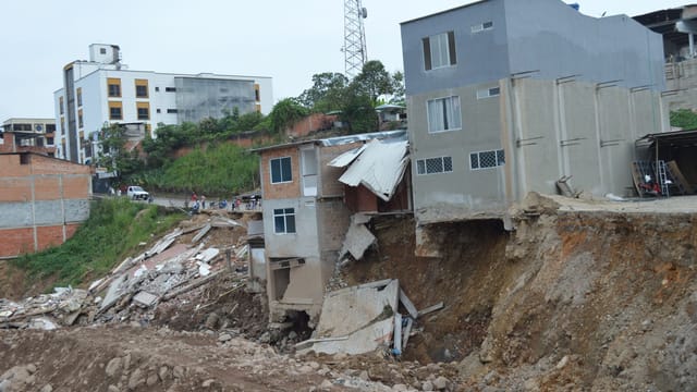 Severely damaged urban buildings after a landslide in Mocoa, Colombia, showcasing destruction.
