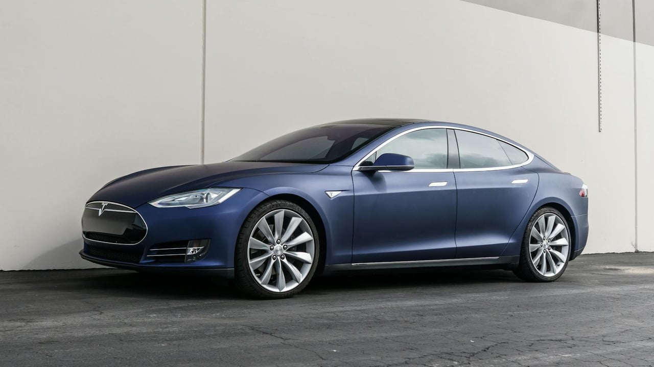 Elegant Tesla Model S parked outdoors against a modern backdrop, showcasing luxury and innovation.