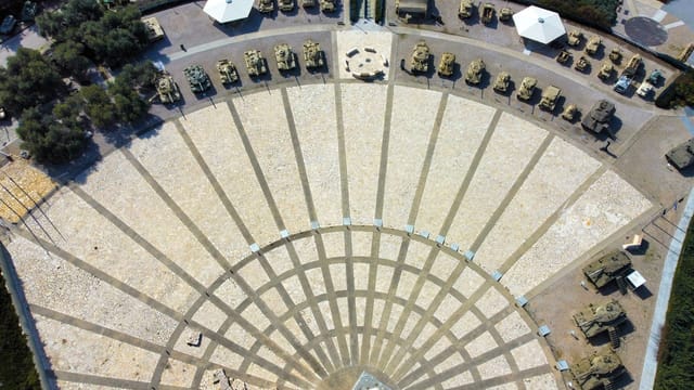 Drone shot of military vehicles displayed outdoors in a museum, Jerusalem, Israel.