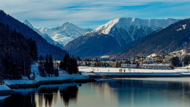 Breathtaking winter landscape of Davos, Switzerland with snow-capped alpine mountains.