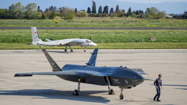 Advanced military drones on a tarmac in Istanbul, Turkey, showcasing modern aerial technology.