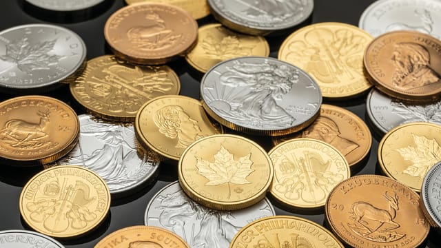 A detailed view of various gold and silver coins, ideal for financial themes.