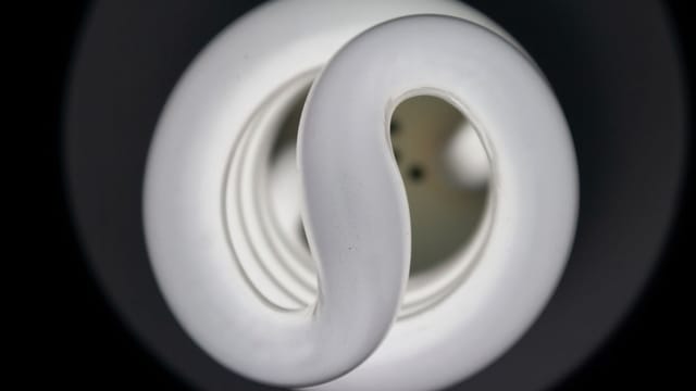 Detailed view of a spiral CFL bulb showcasing its elegant design and artistic lighting effect.