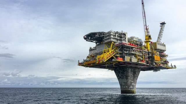 Dramatic view of a large oil platform in Norway's North Sea, symbolizing offshore industry.