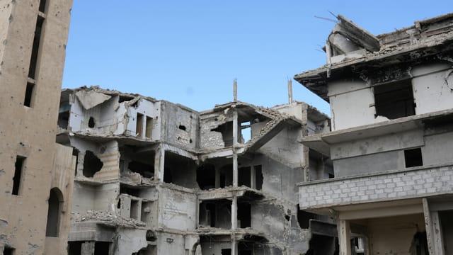 A scene of urban destruction showing damaged buildings in Damascus, Syria.