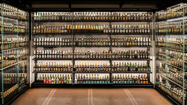 Explore an extensive collection of unopened beer bottles at Carlsberg Brewery in Copenhagen.