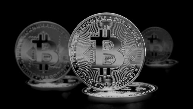 High contrast image of shiny Bitcoin coins symbolizing digital currency and finance.
