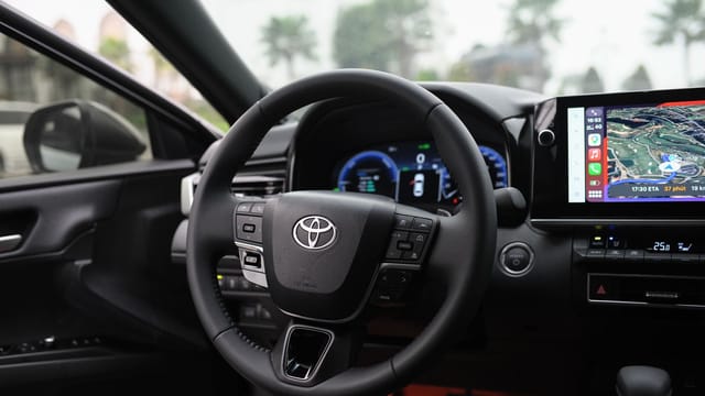Interior view of a modern car showcasing the steering wheel, dashboard, and GPS display screen.