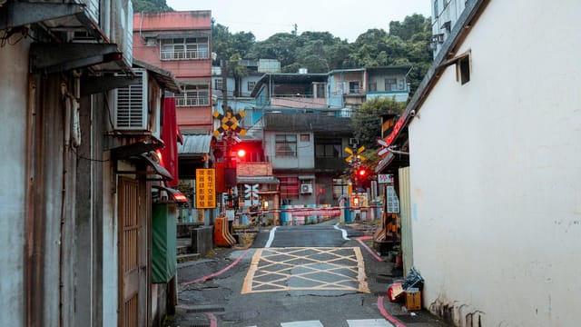 Vibrant street view showcasing Wen An Village level crossing in a bustling urban area.