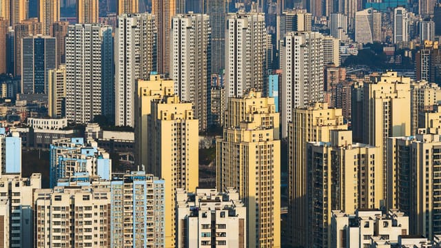 Aerial view of densely packed high-rise buildings in a vibrant urban skyline.
