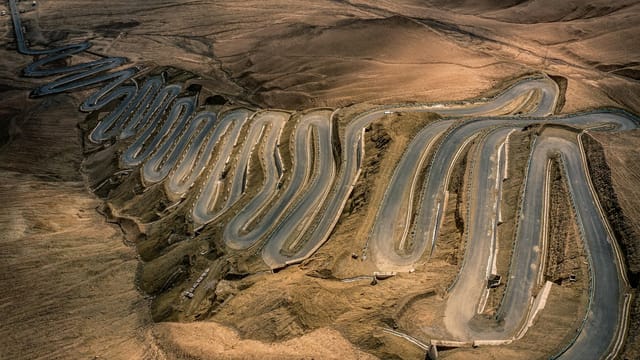 A mesmerizing aerial shot of the winding Panlong Ancient Road in Xinjiang, China.