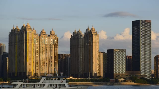 Beautiful Wuhan city skyline with Yangtze River cruise during sunset.