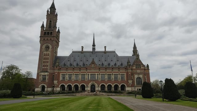 Stunning view of the Peace Palace in The Hague under a cloudy sky.