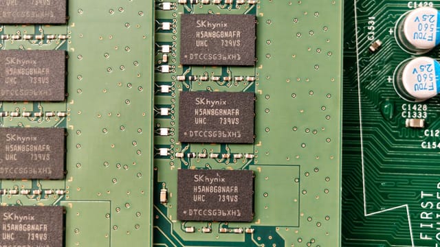 Detailed view of a green circuit board with SK hynix chips, showcasing electronic components.