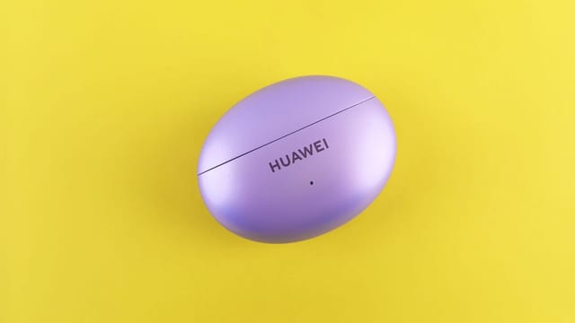 Purple Huawei earbuds case on a vibrant yellow backdrop, showcasing minimal design.
