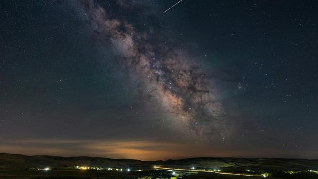 Stunning view of the Milky Way galaxy over the landscape of Inner Mongolia, China.