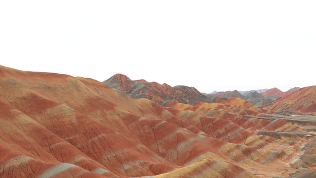 Vibrant stripes of Zhangye Danxia's multicolored hills in China captured in daylight.