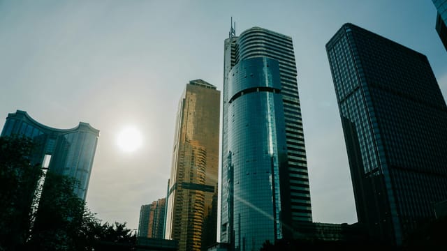 A stunning low-angle view of modern skyscrapers in Guangzhou, China with a beautiful sky.