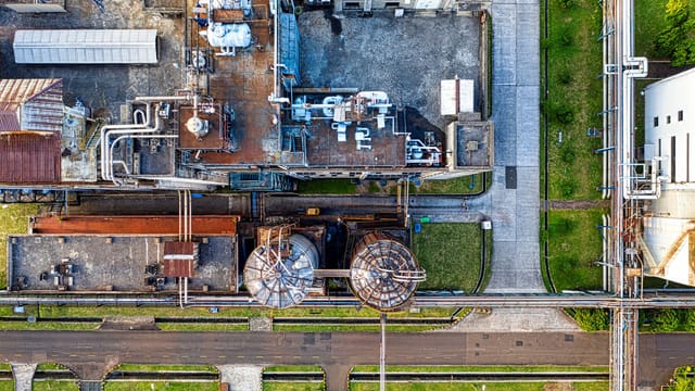 Aerial view of industrial complex consisting of tanks and pipes for producing petroleum products