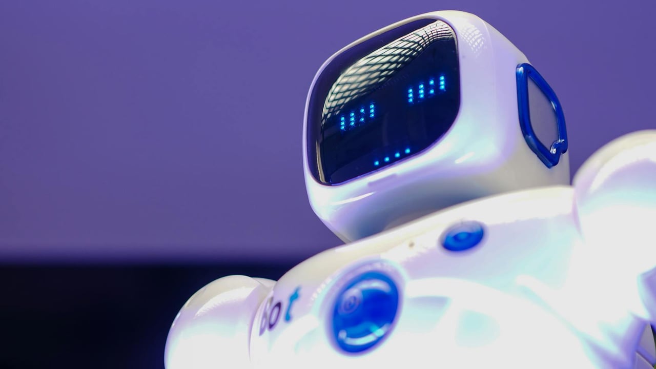 A modern humanoid robot with digital face and luminescent screen, symbolizing innovation in technology.