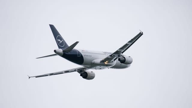 Lufthansa Airbus A320 captured during flight over Munich Airport, Germany.