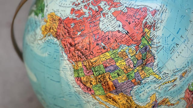 Detailed close-up of a vintage globe highlighting North America with vivid colors.