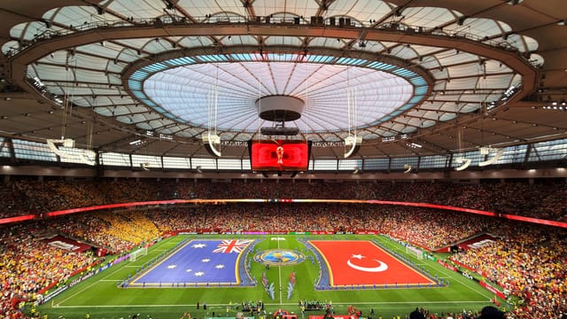 Vibrant soccer match at BC Place, Vancouver, showcasing international team flags.