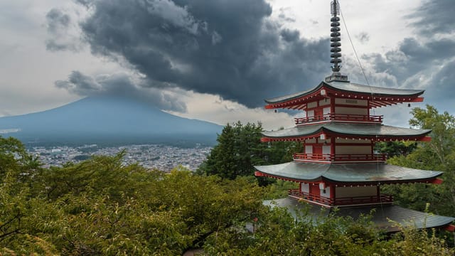 Chureito Pagoda overlooks Mount Fuji under dramatic skies.