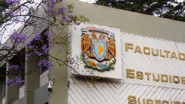 Facade of the Facultad de Estudios Superiores building with detailed emblem, Mexico City.