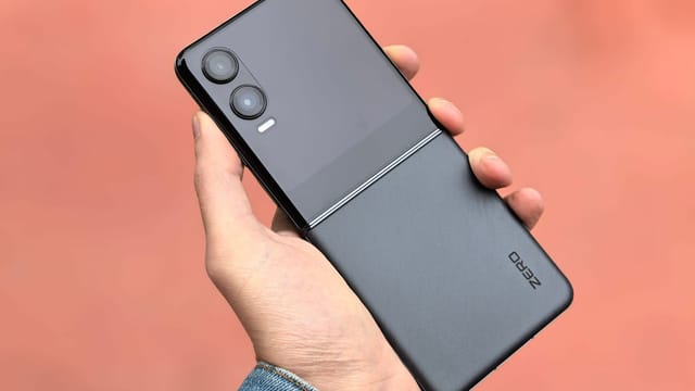 Close-up of a hand holding a modern black flip smartphone, ideal for tech and lifestyle concepts.