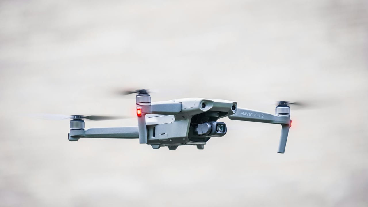 A sleek drone flies through the sky, showcasing modern aerial technology.