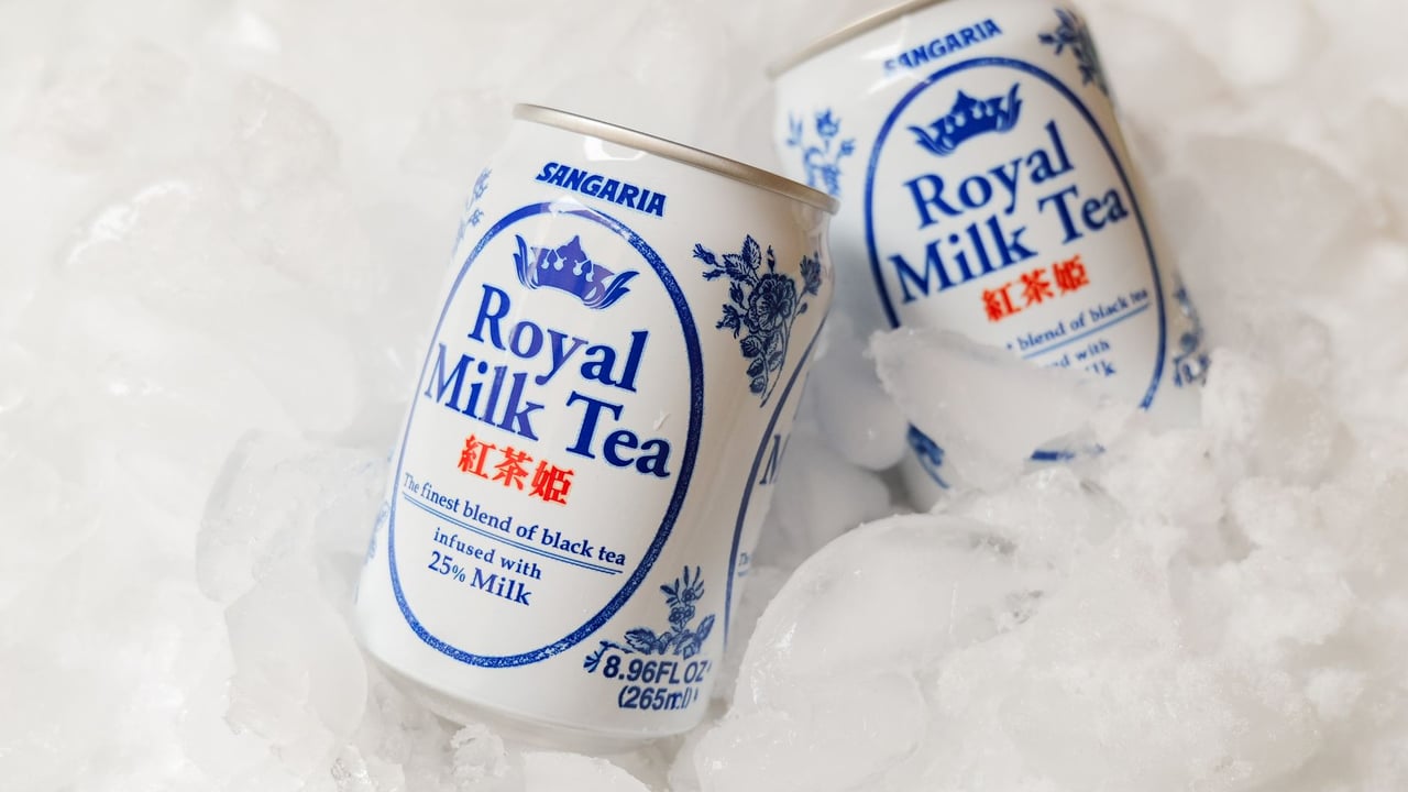 Close-up of chilled Royal Milk Tea cans nestled in ice for refreshment.
