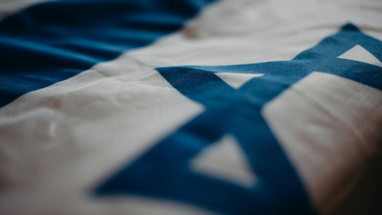 Detail of the Israeli national flag highlighting the Star of David, emphasizing its cultural significance.