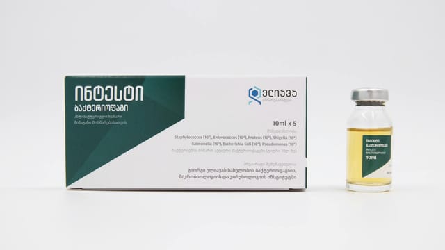 Close-up of a medical vial and package with Georgian text on a white background.