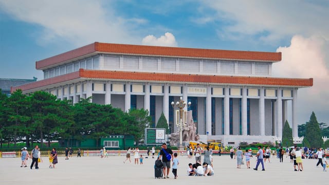 View of the Mausoleum of Mao Zedong in Beijing's Tiananmen Square with visitors.