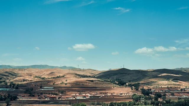 A picturesque view of rolling hills and blue sky in Hohhot, Inner Mongolia, China.