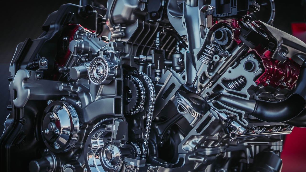 Detailed close-up of a modern metallic car engine with intricate components.