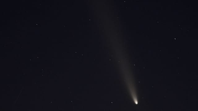 Capture of a comet streaking across a starry night sky in Arizona, United States.