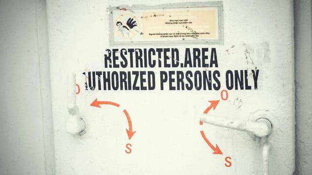 Close-up of a restricted area door with signage emphasizing authorized access only.