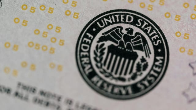 From above eagle on antique column in circle on banknote of Unites States placed on table