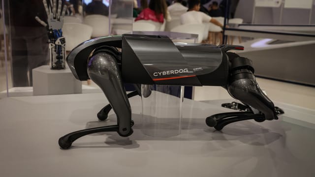 A futuristic robot dog, the Cyberdog, on display in an indoor setting, showcasing advanced robotics technology.