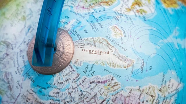 Detailed close-up of a globe focusing on Greenland and surrounding oceans.