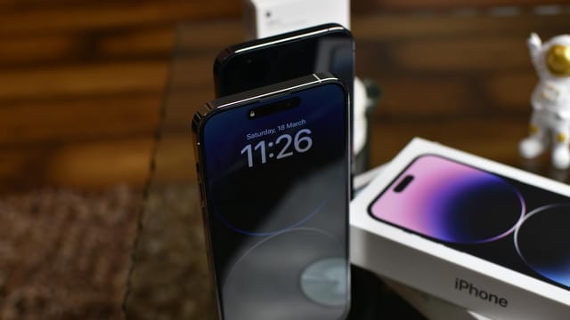 Stylish setup of iPhone 14 Pro showcasing dynamic island feature with accessories.