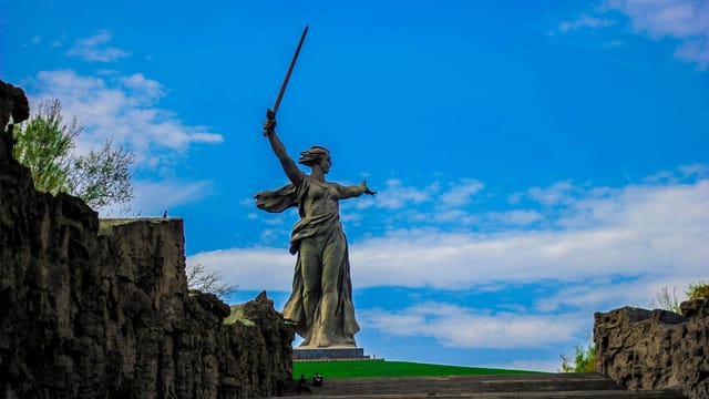 Stunning view of the Motherland Calls statue in Volgograd, Russia under a blue sky.