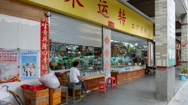 Lively view of a street market in Guangzhou, China displaying traditional goods and colorful decorations.