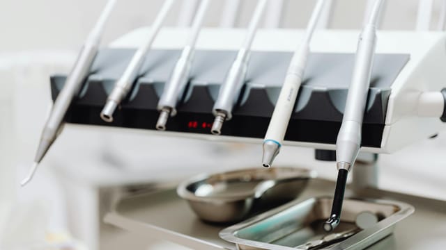 High-tech dental tools and instruments in a dental clinic setting, showcasing advanced healthcare technology.