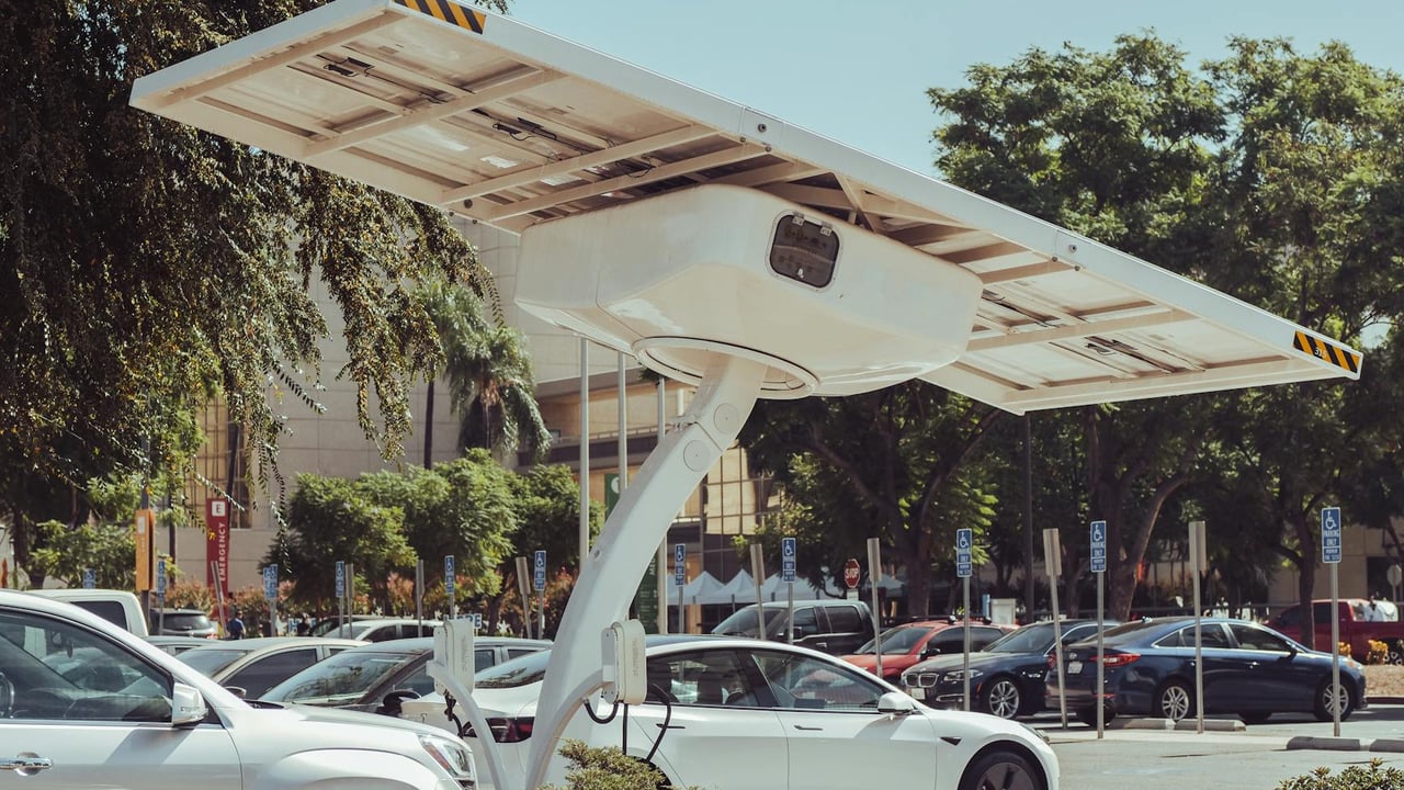 Modern solar-powered charging station for electric vehicles on a sunny day.