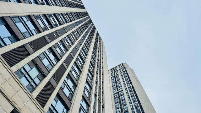 Upward view of contemporary skyscrapers in Tianjin, showcasing modern architectural design.
