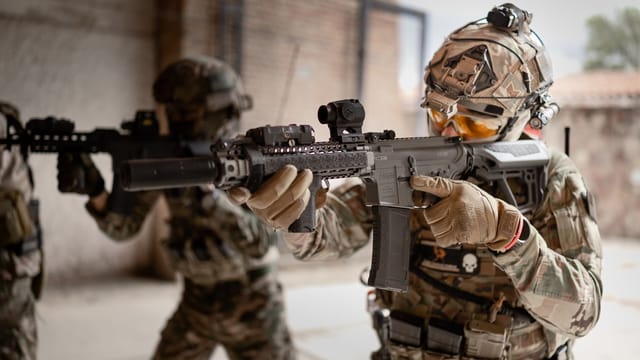 Armored soldiers in action during indoor training exercises, equipped with tactical gear.